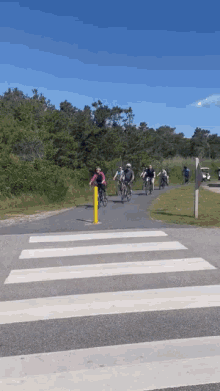 a group of people riding bikes down a path