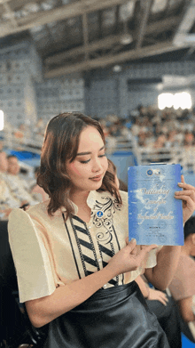 a woman is holding a book that says " delivered grace "