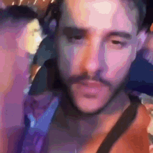 a close up of a man 's face with a beard and mustache