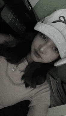 a girl wearing a white hat with a letter s on it