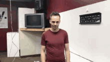 a man in a red shirt is standing in front of a white board that says level mount