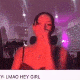 a woman in a red dress is covering her face with her hand and talking into a microphone .