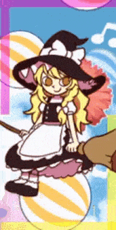 a girl in a witch costume is sitting on a candy ball