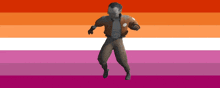a man in a brown jacket is dancing in front of a lesbian flag