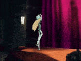 a monster high doll is standing on a stage