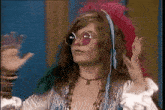 a woman wearing sunglasses and a headband is dancing