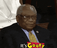 a man in a suit and tie with the words it 's goofy on the bottom