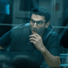 a man wearing glasses and a backpack is screaming