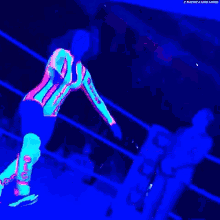 a glow in the dark wrestler is standing in a ring .