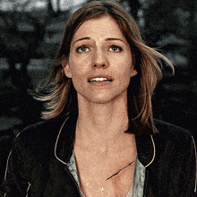 a close up of a woman 's face with a scar on her chest