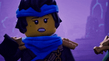 a ninjago character with a blue scarf around her neck