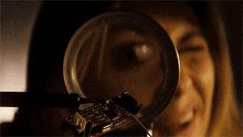 a woman is looking through a magnifying glass at something