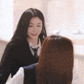 two girls are standing next to each other and one is wearing a tie