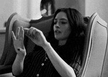 a black and white photo of a woman in a striped shirt