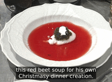 a bowl of red beet soup with caviar and whipped cream on top