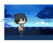 a boy stands in front of an aquarium with fish in it