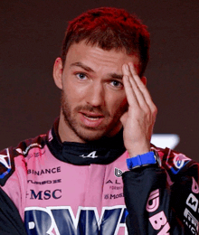 a man wearing a pink shirt with msc written on it
