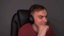 a man wearing headphones is smiling and says " biblbiblbibl " in russian