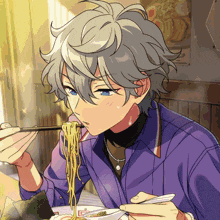 a man in a purple shirt is eating ramen with chopsticks