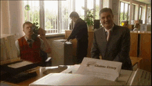 a man in a suit is holding a piece of paper that says " claims grace "