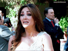 a woman in a white dress is standing in front of a man in a suit and tie with the hashtag anahioverdose