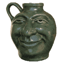 a green vase with a face on it