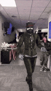 a woman in a military uniform is walking down a hallway with a tiktok watermark on the bottom