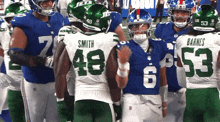 a group of football players including smith and barnes are standing together