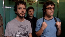 a man wearing a rip dancin t-shirt stands in an elevator