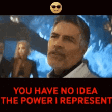 a man wearing sunglasses is standing in front of a group of people and says `` you have no idea the power i represent ''