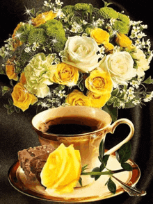 a cup of coffee next to a bouquet of yellow and white flowers