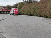 a red and white van is parked on the street