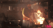 a man is cooking in a kitchen with xhk written on the bottom