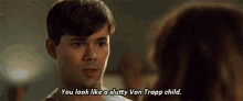 a man is talking to a woman and says `` you look like a slutty von trapp child '' .
