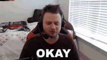a man wearing headphones and a headset says okay
