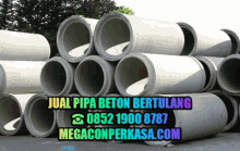 a bunch of concrete pipes stacked on top of each other with the website megaconperkasa.com at the bottom