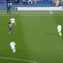 a group of men are playing soccer on a field with one wearing a barcelona jersey