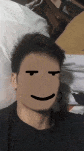 a man laying on a bed with a smiley face on his face