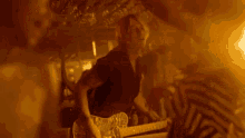 a group of people are dancing in a dark room with smoke coming out of the ceiling .