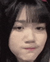 a close up of a woman 's face with a funny face .
