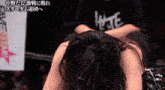 a woman is kneeling down with her head down in front of a sign that says save star
