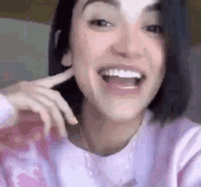 a close up of a woman 's face with her mouth open and a smile on her face .