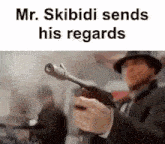 a man in a suit and hat is holding a gun in his right hand .