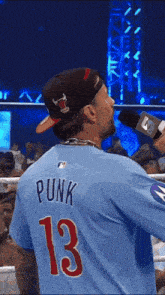 a man wearing a blue shirt with punk 13 on the back