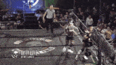 two wrestlers in a ring with the words iwtv live on the bottom right