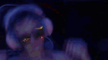 a blurry picture of a person dancing in a dark room with red lights .