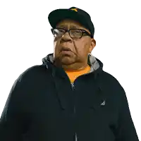 a man wearing a hat and glasses is wearing a black jacket with the word nautica on it
