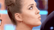 a close up of a woman 's face with the number 1 above her