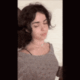 a close up of a woman 's face with her eyes closed