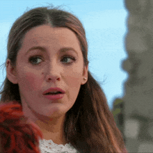 a close up of a woman 's face with a surprised expression